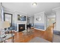 Spacious living room with hardwood floors, fireplace, and large windows at 8352 Primanti Blvd, Raleigh, NC 27612