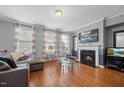 Living room features hardwood floors, fireplace and large windows at 8352 Primanti Blvd, Raleigh, NC 27612