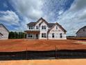 Two-story home under construction, showcasing a spacious layout and future landscaping potential at 88 Tennyson Dr, Garner, NC 27529