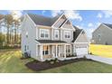Two-story house with gray siding, white trim, and a two-car garage at 88 Tennyson Dr, Garner, NC 27529