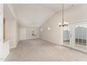 Spacious living room with vaulted ceiling, carpet, and access to backyard at 9104 Colony Village Ln, Raleigh, NC 27617