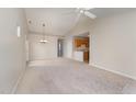 Open living room and kitchen with vaulted ceiling and carpet at 9104 Colony Village Ln, Raleigh, NC 27617