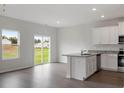Modern kitchen with white cabinets, granite counters, and stainless steel appliances at 103 Scoville St, Oxford, NC 27565