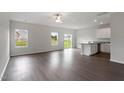 Open concept living room and kitchen with hardwood floors and sliding glass doors at 103 Scoville St, Oxford, NC 27565