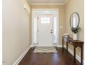 Bright entryway with hardwood floors, white door and console table at 116 Telluride Trl, Garner, NC 27529