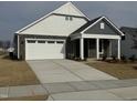 Two-story house with gray and white siding, a stone facade, and a two-car garage at 1315 Richfield Oaks Dr, Homesite 3, Fuquay Varina, NC 27526