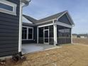 Screened porch with gray railings and a concrete patio at 1315 Richfield Oaks Dr, Homesite 3, Fuquay Varina, NC 27526