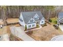 Two-story house with driveway and backyard in wooded area at 1513 Hoke Landing Ln, Raleigh, NC 27603