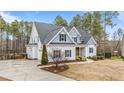 Two-story house with gray siding, stone accents, and landscaping at 1513 Hoke Landing Ln, Raleigh, NC 27603