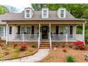 Inviting front porch features rocking chairs, decorative wreath, and manicured landscaping at 1741 W Blackman Rd, Dunn, NC 28334