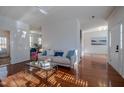 Bright living room with hardwood floors, a sofa, and a coffee table at 2 Woodsage Ln, Durham, NC 27713