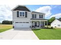 Beautiful two-story home with a two-car garage, manicured lawn, and craftsman-style details at 223 Johnson Ridge Way, Four Oaks, NC 27524