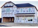 New construction home with a large covered porch at 223 Johnson Ridge Way, Four Oaks, NC 27524