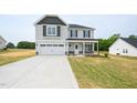 Charming two-story home with a two-car garage and manicured front yard at 223 Johnson Ridge Way, Four Oaks, NC 27524