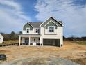 Charming two-story home with a welcoming front porch and an attached two-car garage at 236 Johnson Ridge Way, Four Oaks, NC 27524