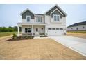 Inviting two-story home boasting a covered front porch and attached two-car garage at 236 Johnson Ridge Way, Four Oaks, NC 27524