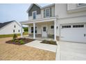 Welcoming covered porch with stone accents and white columns on a charming home at 236 Johnson Ridge Way, Four Oaks, NC 27524
