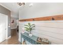 Bright entryway with shiplap wall, console table, and coat rack at 2407 Cattail Pond Dr, Zebulon, NC 27597