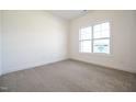Bright, carpeted bedroom with a large window providing natural light, creating a cozy and inviting space at 247 Johnson Ridge Way, Four Oaks, NC 27524