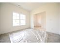 Bright, empty living room showcasing ample natural light through a large window at 247 Johnson Ridge Way, Four Oaks, NC 27524