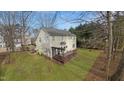 House backyard view with deck and wooded area at 2548 Deanwood Dr, Raleigh, NC 27615