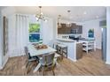Eat-in kitchen with island, hardwood floors, and modern cabinetry at 2904 Huxley Way, Apex, NC 27502