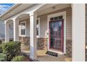 Front porch with stone accents and a burgundy door at 309 Coalyard Dr, Garner, NC 27529