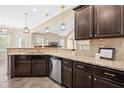 Kitchen featuring granite countertops, dark cabinets, stainless steel appliances at 347 Country Mill Way, Fuquay Varina, NC 27526