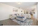 Open living room with a sectional sofa, ottoman, and view into the kitchen area at 370 Hickory Run Ln, Franklinton, NC 27525