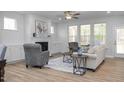 Bright living room with fireplace, hardwood floors, and access to back porch at 4809 Bristol Meadow Dr, Raleigh, NC 27603