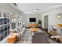 Virtually staged living room with gray couches and wood accents at 5340 Fayetteville Rd, Durham, NC 27713