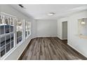 Bright living room with large windows and wood-look flooring at 5340 Fayetteville Rd, Durham, NC 27713