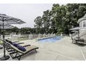 Relaxing pool area with lounge chairs and lake view at 5891 Baker Ln, Rocky Mount, NC 27803