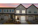 Charming townhome showcasing a well-manicured lawn, attached garage, and craftsman-style details at 608 Marshskip Way, Rolesville, NC 27587