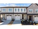 Charming townhome featuring attached garage, craftsman details, and manicured front yard at 610 Marshskip Way, Rolesville, NC 27587