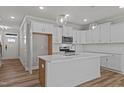 Bright, eat-in kitchen with stainless steel appliances, quartz countertops, and white cabinetry at 610 Marshskip Way, Rolesville, NC 27587