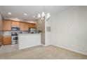 Open concept dining area with kitchen and chandelier at 617 Eyam Hall Ln, Apex, NC 27502
