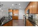 Well-lit kitchen boasts granite countertops, stainless steel appliances, and wood-look floors at 618 N Boylan Ave # 826, Raleigh, NC 27603