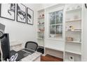 Bright home office featuring custom built-in shelving and granite desktop, perfect for remote work at 620 Rollins Mill Rd, Holly Springs, NC 27540