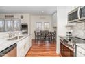 Modern kitchen with stainless steel appliances, granite counters, and an adjacent dining area at 620 Rollins Mill Rd, Holly Springs, NC 27540
