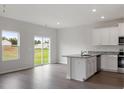 Modern kitchen with white cabinets, granite countertops, and stainless steel appliances at 821 Rhino Bnd, Oxford, NC 27565