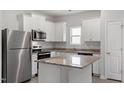 Modern kitchen boasts stainless steel appliances, granite countertops, and ample cabinet space at 910 Rhino Bnd, Oxford, NC 27565