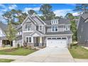Charming two-story home with gray siding, stone accents, and a well-manicured lawn at 9164 Dupree Meadow Dr # 14, Angier, NC 27501