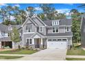 Charming two-story home with gray siding, stone accents, and a well-manicured lawn at 9164 Dupree Meadow Dr # 14, Angier, NC 27501