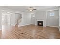 Open-concept living room with fireplace, wood floors, neutral walls, and lots of natural light at 9164 Dupree Meadow Dr # 14, Angier, NC 27501