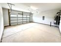 Spacious two-car garage with bright lighting, offering ample room for vehicles and storage at 111 Southern Estates Dr, Sanford, NC 27330