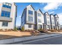 Modern townhome community with gray siding and landscaping at 1179 Cottonsprings Dr, Wendell, NC 27591
