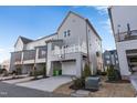 Townhouse rear view, showcasing deck, garage, and basketball hoop at 1179 Cottonsprings Dr, Wendell, NC 27591