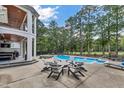 Inviting pool area with lounge chairs and a fire pit at 124 Dallavia Ct, Morrisville, NC 27560