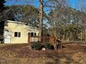 Manufactured home with deck and surrounding trees at 165 Wakeline Dr, Wendell, NC 27591